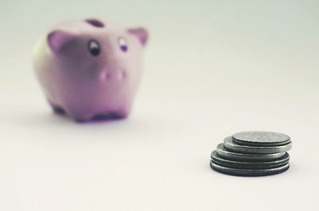 piggy bank with coins that have been saves because of 3m thinsulate window film.